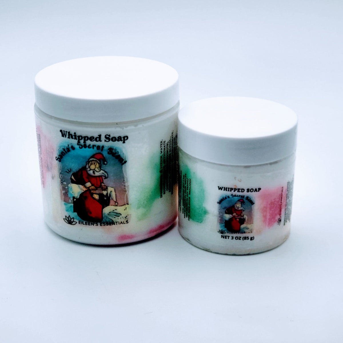 Large and 3 oz Santa's Secret Scent whipped soap jars standing side by side with Santa labels.